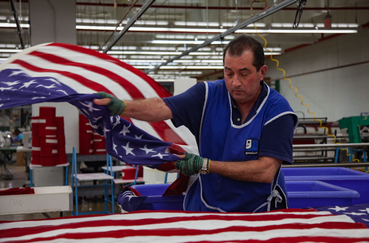 Blind worker tossing a United States Flag