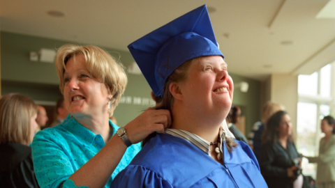 Happy mom and daughter with a disability at graduation
